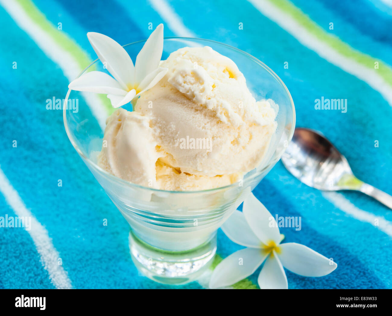 Piatto di gelato alla vaniglia con fiori di plumeria Foto Stock