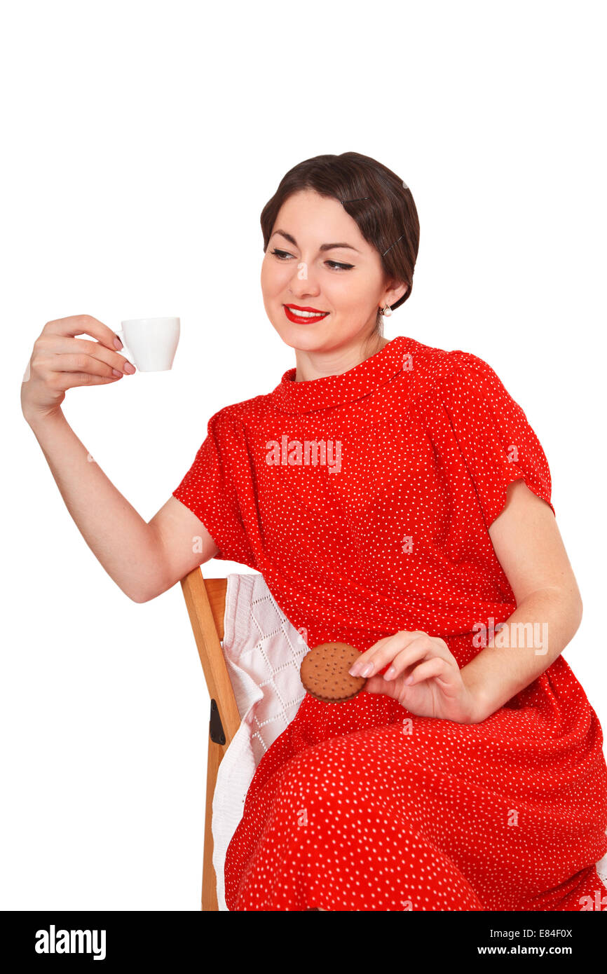 Donna che mantiene una tazza di caffè e biscotti Foto Stock