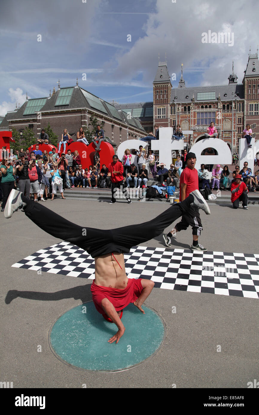 Breakdancer eseguendo in Amsterdam.turisti sul mio segno di Amsterdam.Di fronte al Rijksmuseum.io amo amsterdam. Foto Stock