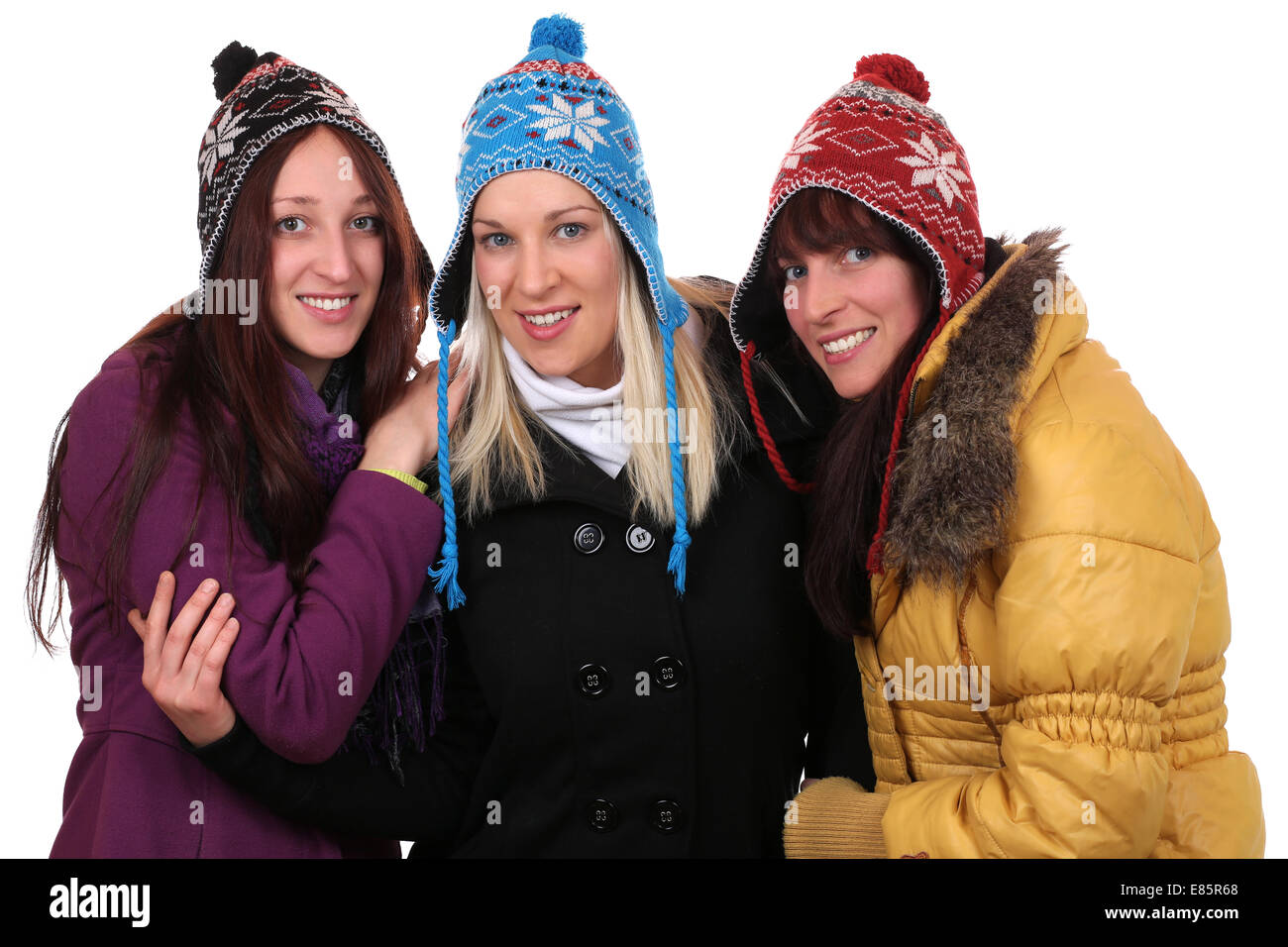 Gruppo di sorridere le giovani donne persone in inverno con i guanti e i cappelli, isolato su sfondo bianco Foto Stock