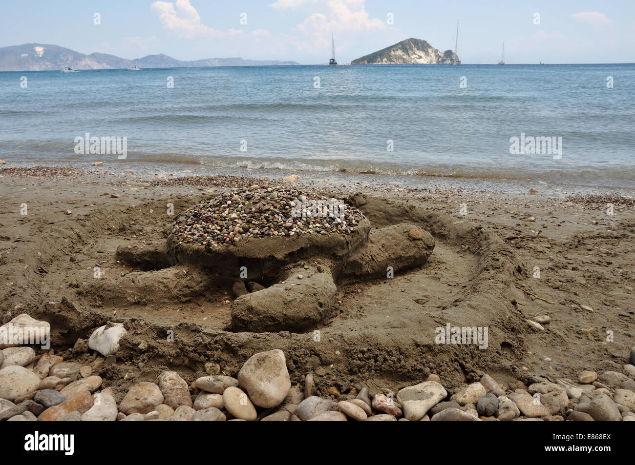 Carreta tartaruga di mare la scultura di sabbia sulla spiaggia di Keri e vista in lontananza Marathonisi isolotto. Foto Stock