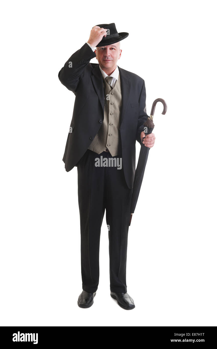 Persone di mezza età imprenditore in un retrò business suit con ombrellone isolato su bianco. Foto Stock
