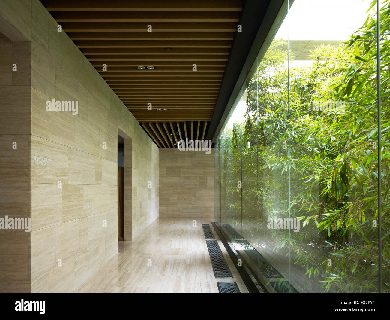 Sibilo Rock Golf Clubhouse, Chuncheon, Corea del Sud. Architetto: Mecanoo, 2012. Corridoio di vetrate con vista verso outdoor gard Foto Stock