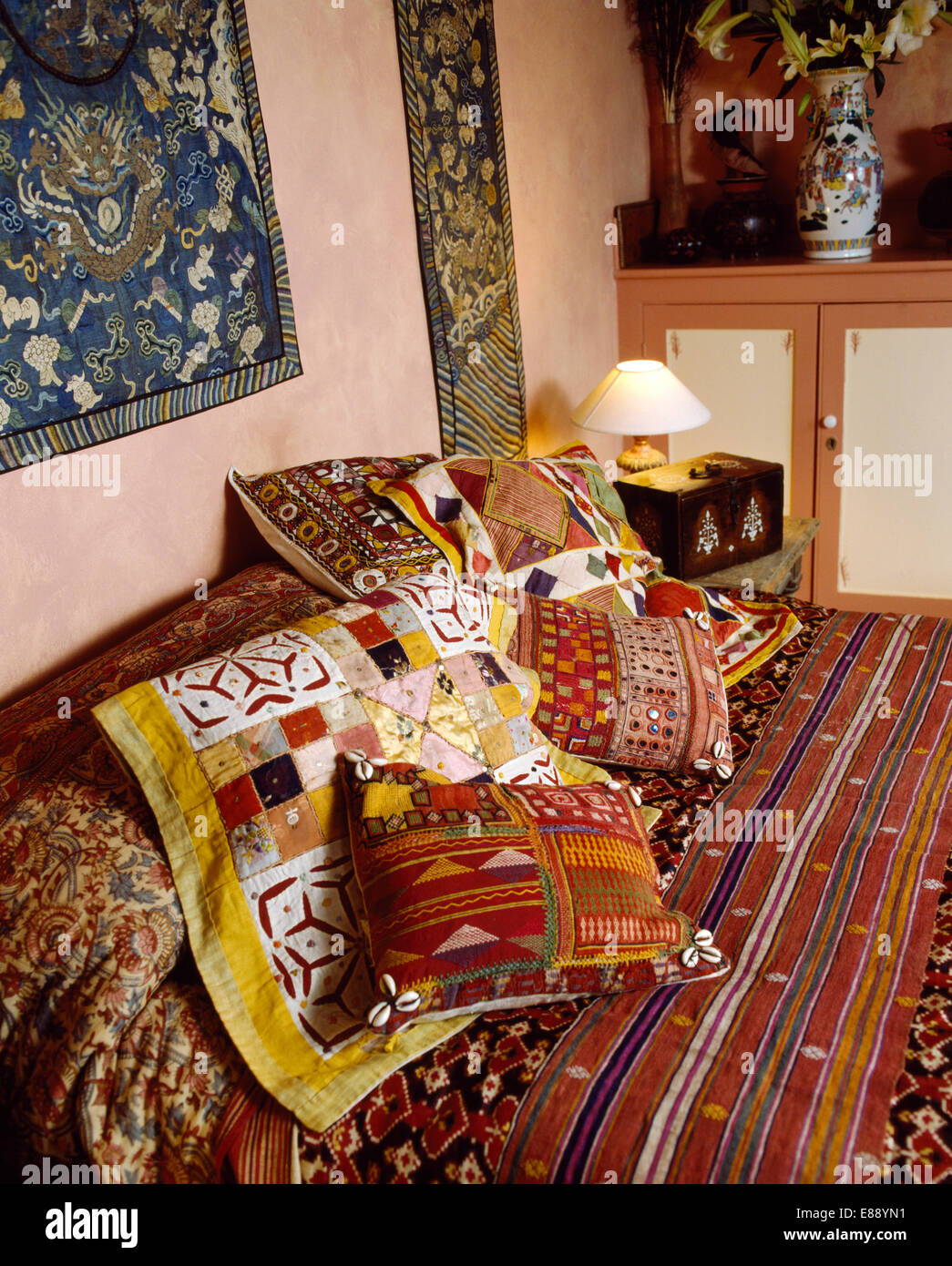 Indiani coloratissimi cuscini e copriletto sul letto in etnico-camera da  letto di stile Foto stock - Alamy
