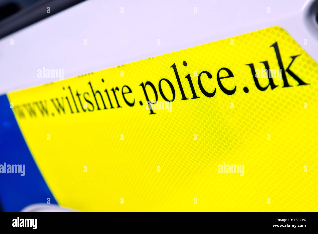 Il giorno glo segno sul lato di un bianco britannico, Wiltshire auto della polizia dato l'indirizzo del sito web della constabulary locale Foto Stock