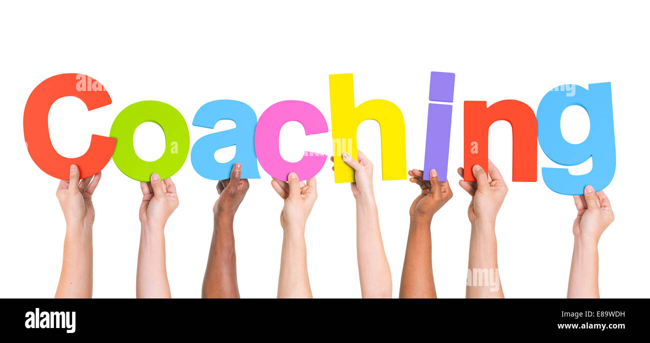 Diverse mani tenendo la parola Coaching Foto Stock