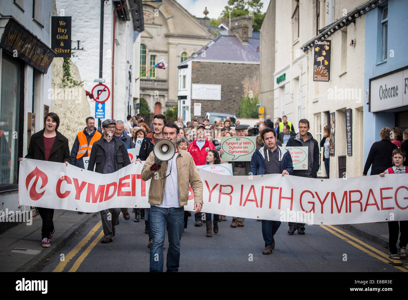 Pwllheli, Wales, Regno Unito. 4 Ottobre, 2014. Lingua gallese società (Cymdeithas yr Iaith Gymraeg) presidente, JAMIE BEVAN, conduce rally che ha invitato le autorità locali e il Gallese di governo ad adottare le misure di pianificazione che trarrebbe vantaggio le necessità locali. Hanno tenuto un rally e marcia di protesta a Pwllheli, il Galles del Nord, per sollevare la consapevolezza della loro campagna contro le attuali misure di pianificazione che essi sostengono che risulterebbe deleterio per la sostenibilità di Lingua gallese europee. Credito: Rhys Llwyd/Alamy Live News Foto Stock