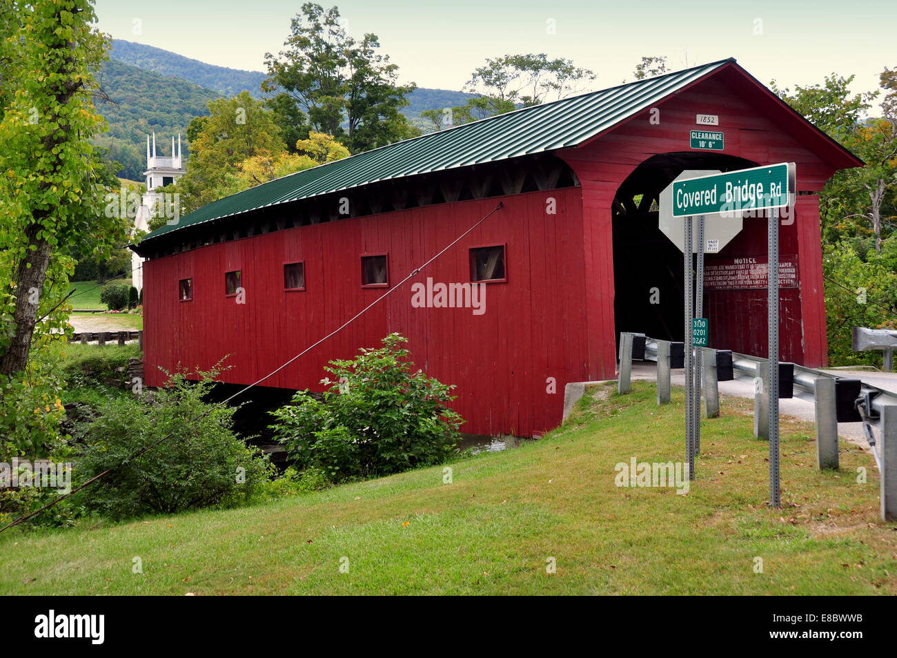 West Arlington, Vermont: 1852 Rosso coperto ponte sopra il fiume Battenkill e il vicino villaggio coloniale chiesa * Foto Stock