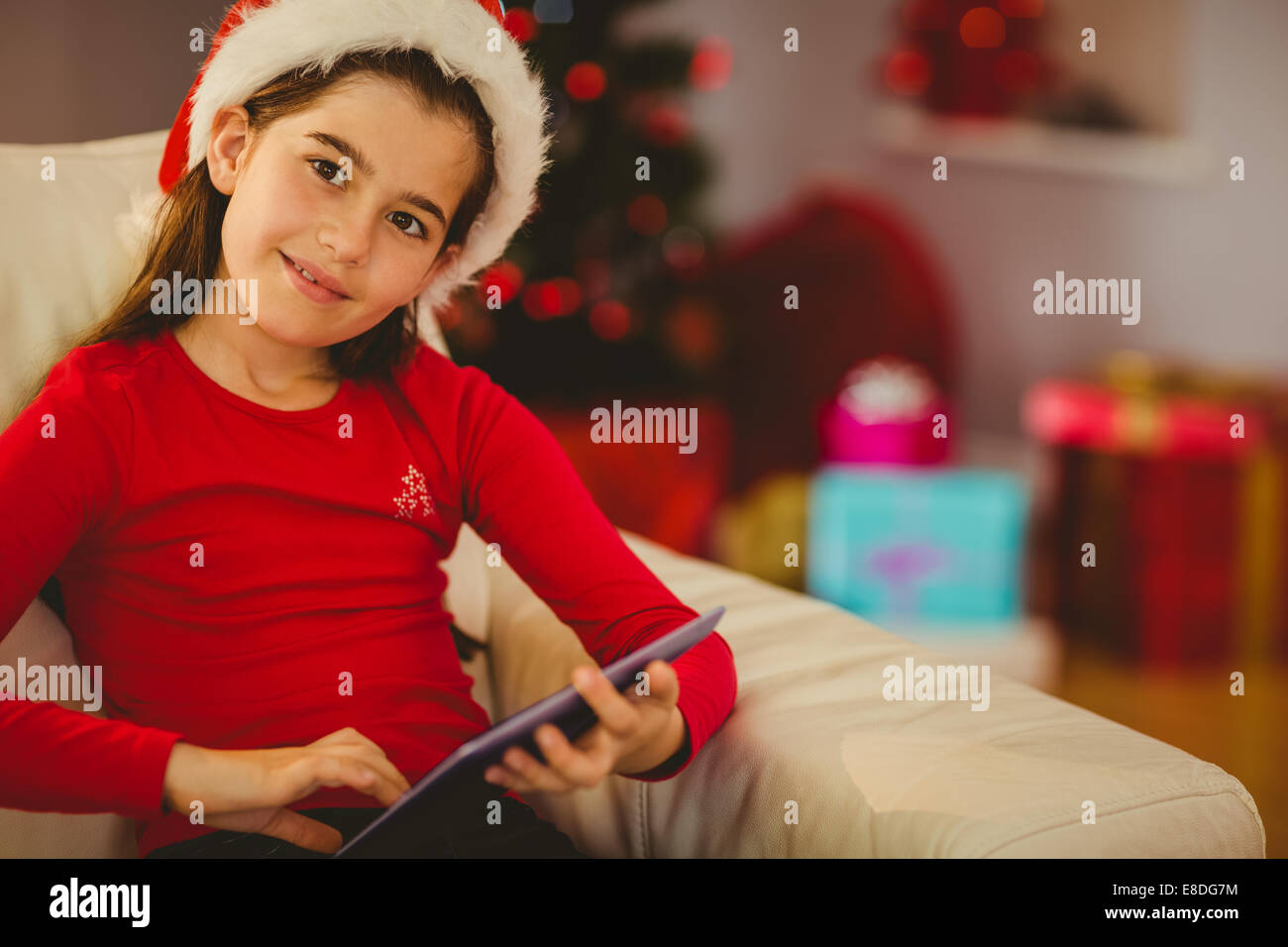 Festive bambina utilizzando tablet pc sul lettino Foto Stock