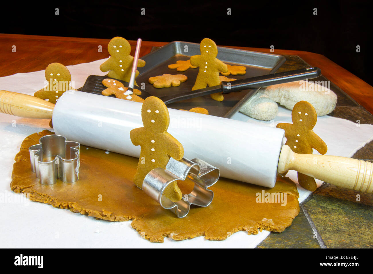 Gingerbread cookies rolling out, il taglio e la decorazione di gingerbread cookie Foto Stock