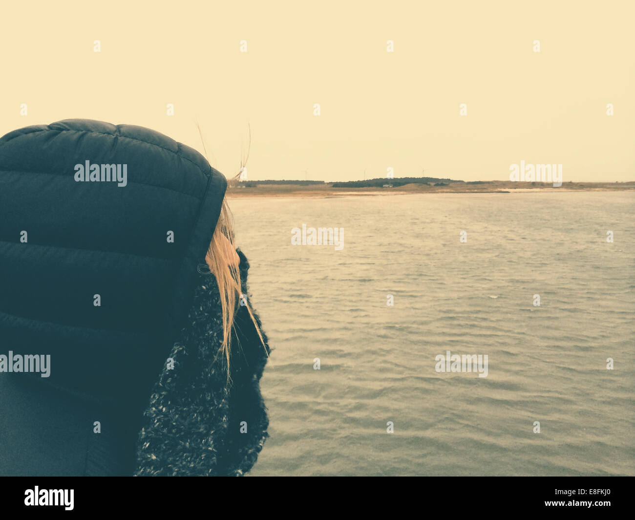 Primo piano di una donna in piedi su una barca con un cappuccio che copre il suo viso, Fanoe, Jutland, Danimarca Foto Stock