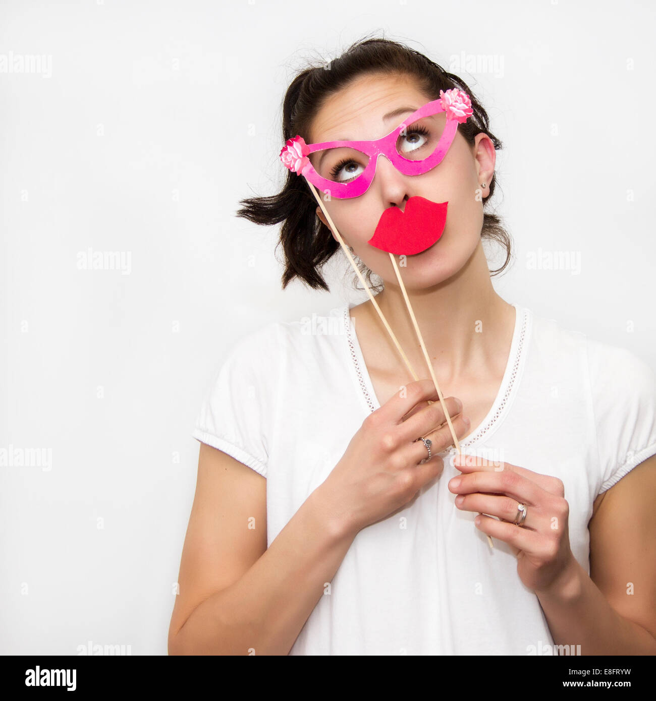 Donna che mantiene le labbra e occhiali maschere Foto Stock