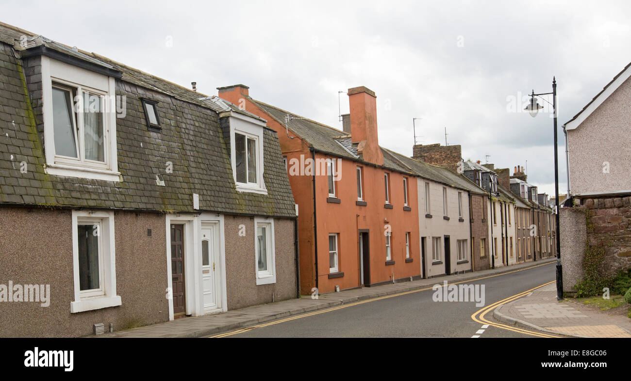 Fila di un blando case Terrazza stipati insieme lungo la strada stretta nella città costiera di Arbroath, Scozia Foto Stock