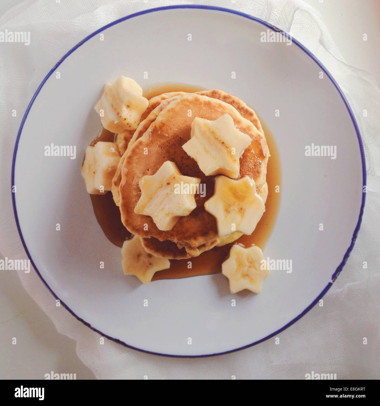 Pila di pancake con banana e sciroppo d'acero Foto Stock