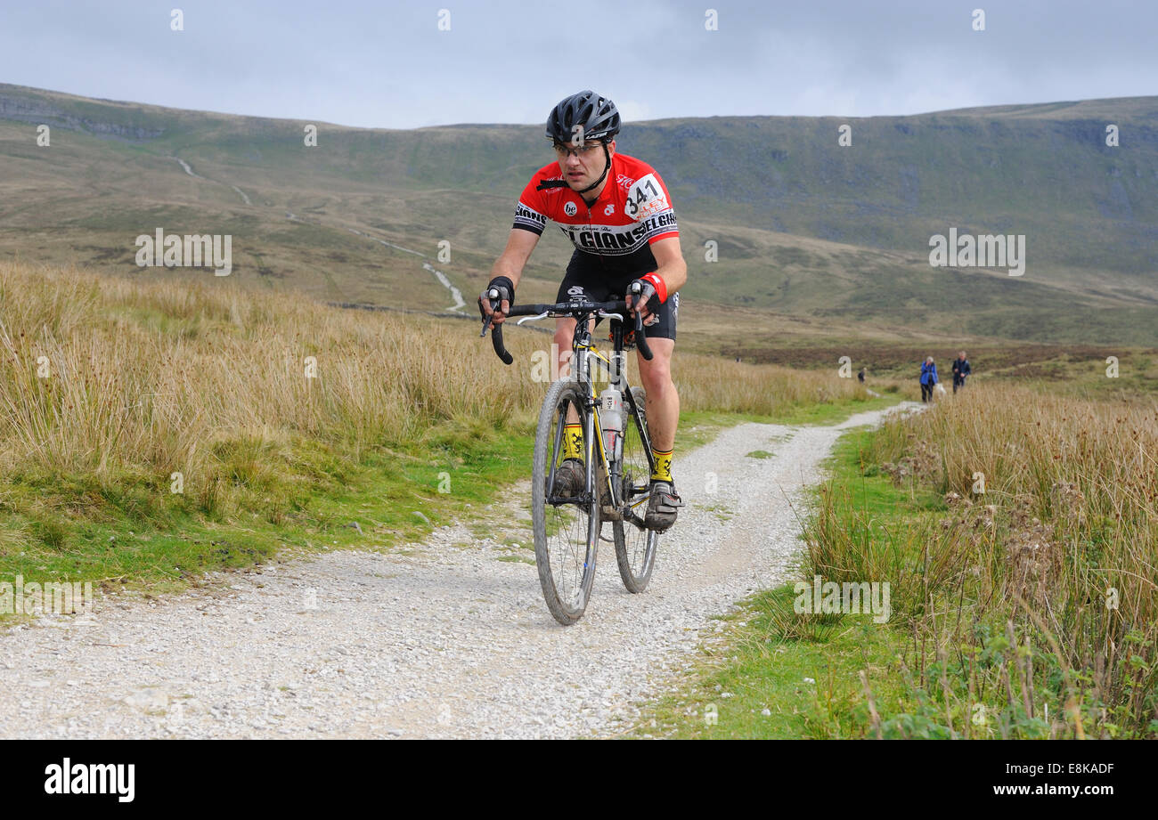 Pilota in tre picchi di ciclocross gara con fells in background Foto Stock