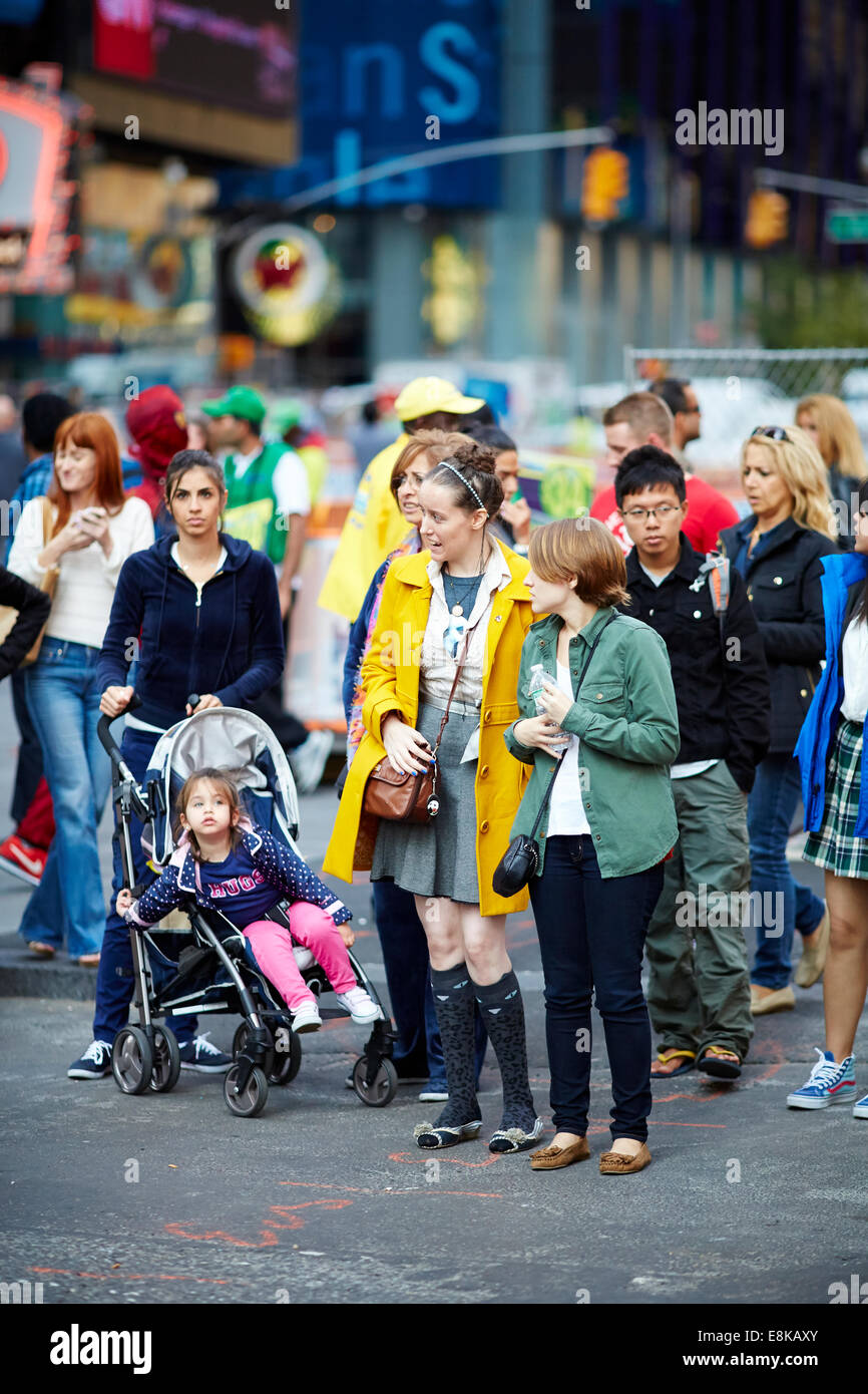 New York City NYC pedoni attendere sul marciapiede in attesa di attraversare in Times Square Foto Stock