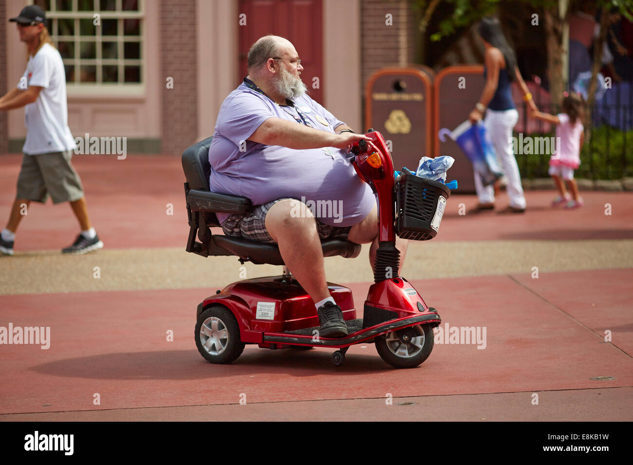 Florida USA Disneyland Fat persona su una mobilità scooter Foto Stock