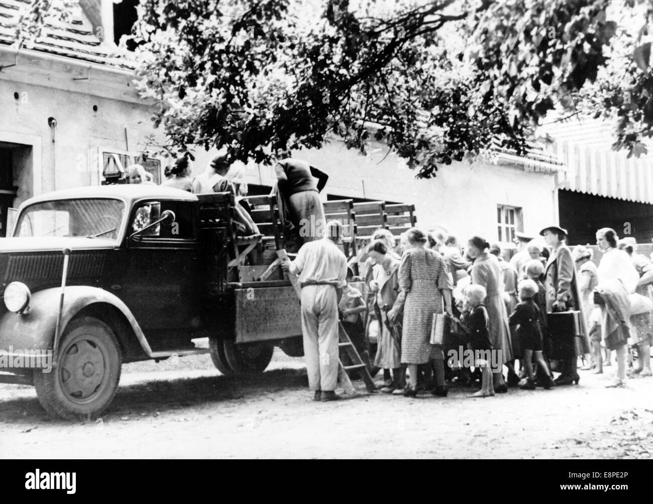 La foto della propaganda nazista mostra che i rifugiati Volkdeutsche sono stati trasportati da una città di confine tedesca in un campo profughi nell'agosto 1939. Il testo nazista originale sul retro dell'immagine recita: 'Vittime della furia polacca della persecuzione. Le persone di Volksdeutsch provenienti dall'Uppe Slesia, che sono state in grado di fuggire dal terrore dei voivodes Graczynski e dei suoi banditi sul suolo tedesco, sono trasportate nei campi profughi con camion". Fotoarchiv für Zeitgeschichtee - NESSUN SERVIZIO DI CABLAGGIO Foto Stock