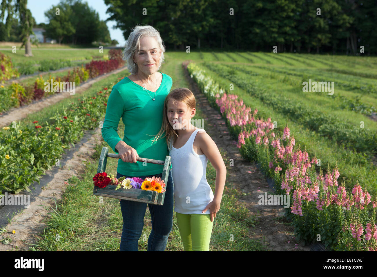 Nonna caucasica e nipote a caccia di fiori in agriturismo Foto Stock