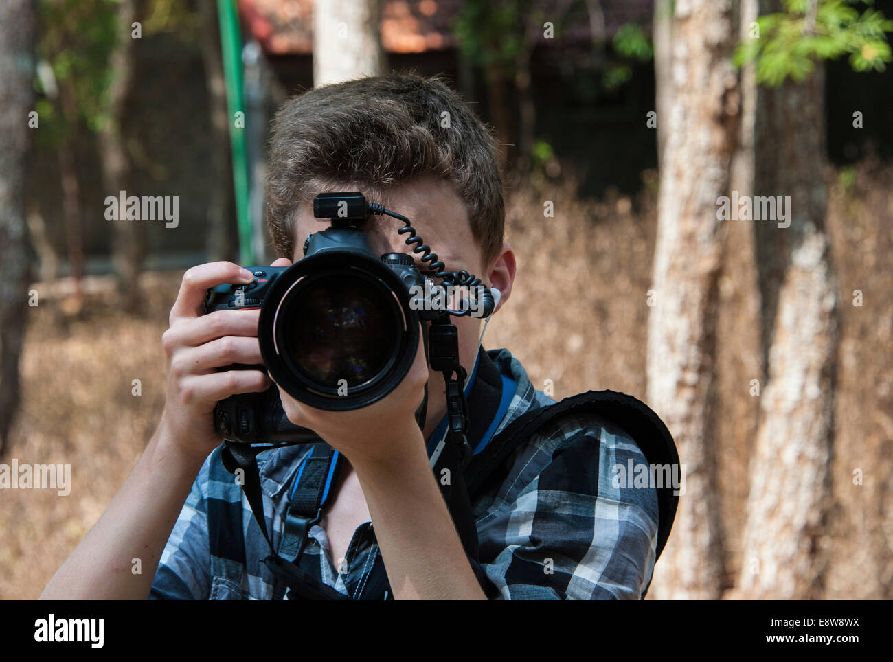 Adolescente di scattare una foto con una fotocamera professionale Foto Stock