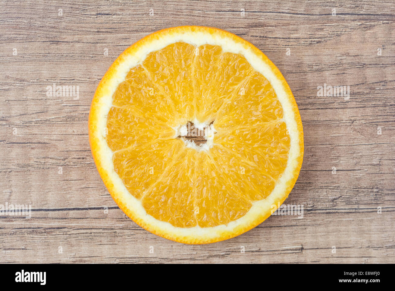 Fetta di arancia sul tavolo di legno Foto Stock