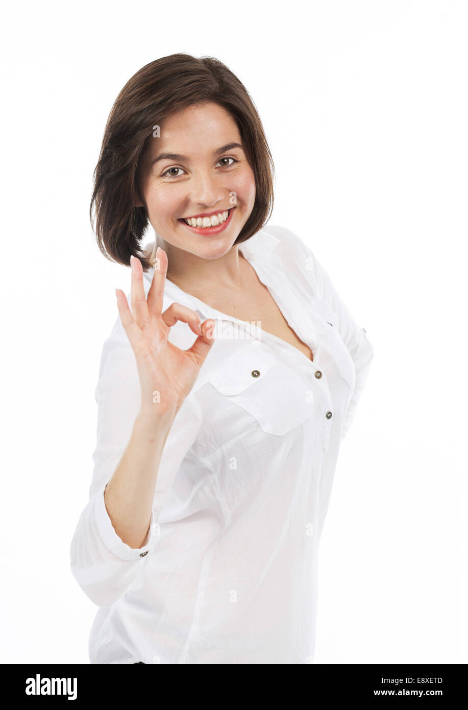 Ritratto di donna sorridente avente un gesto positivo, isolato su bianco Foto Stock