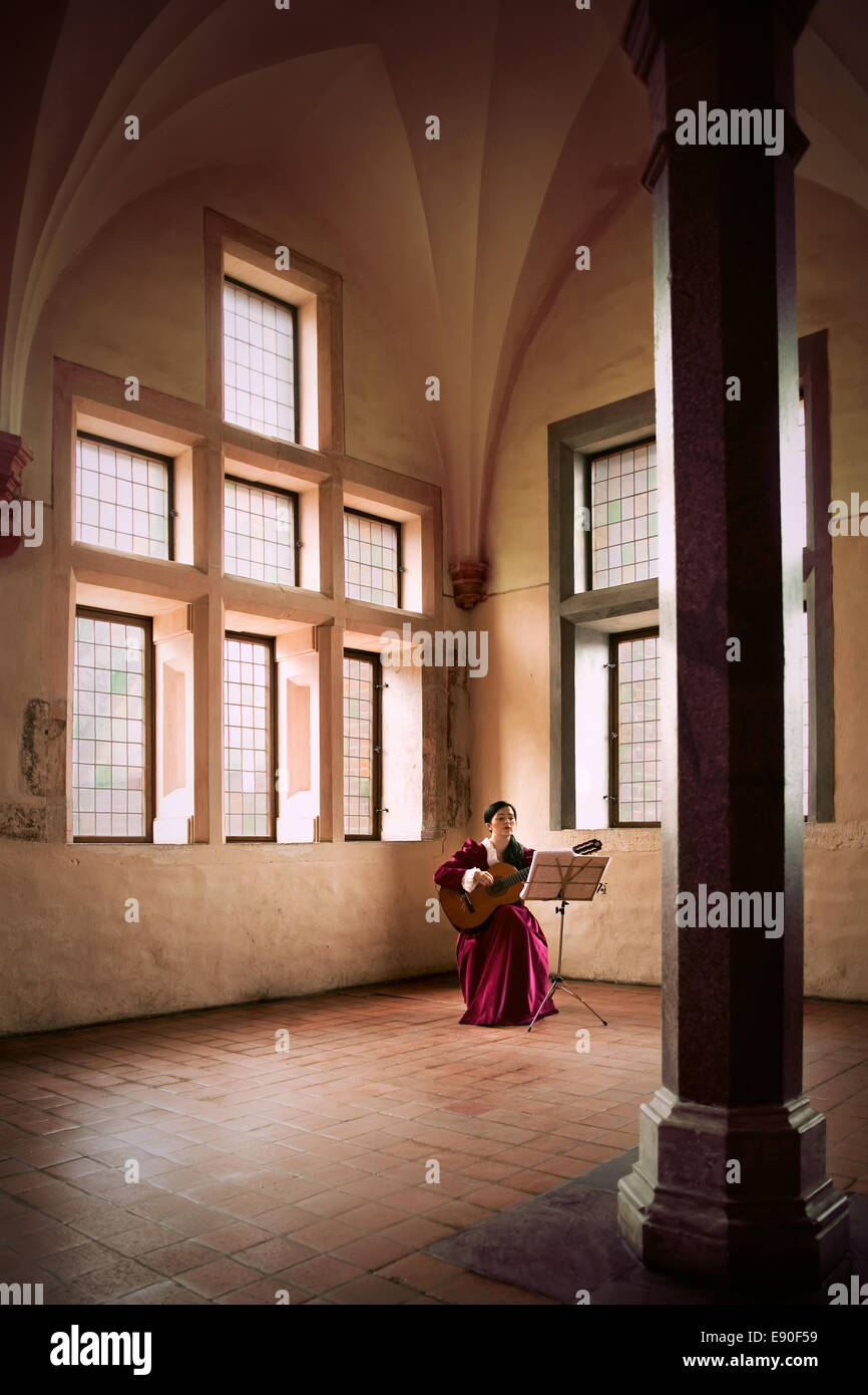 La donna a suonare la chitarra nel castello di Malbork. Foto Stock