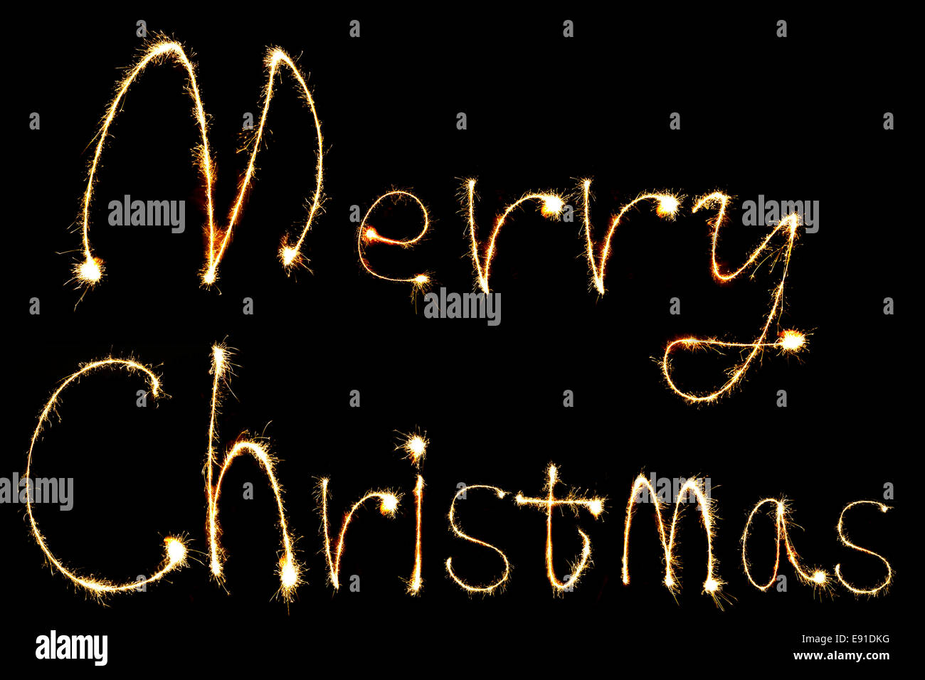 Burning sparkler stick e scrittura Merry Chistmas scintillante parole su sfondo nero Foto Stock