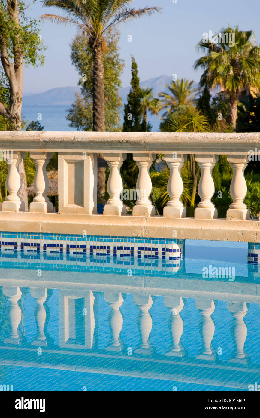 Colonia de Sant Pere, Maiorca, isole Baleari, Spagna. Balaustra in pietra si riflette nella piscina del complesso di appartamenti di lusso. Foto Stock
