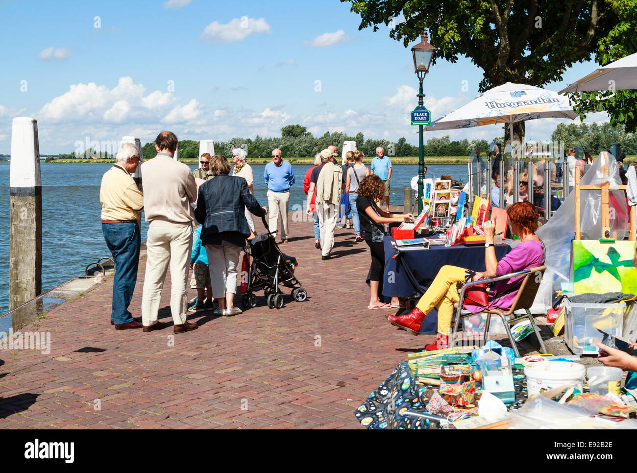 Dordrecht, Paesi Bassi - 11 agosto 2013: i visitatori a passeggiare davanti alle bancarelle sul lungomare vendita di arte in sun. Foto Stock