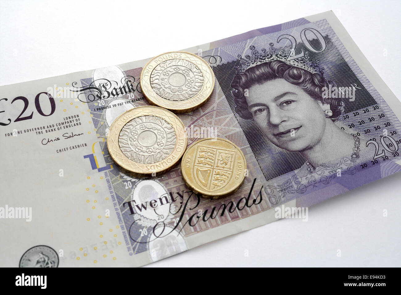 British £20 libbre nota con monete Foto Stock