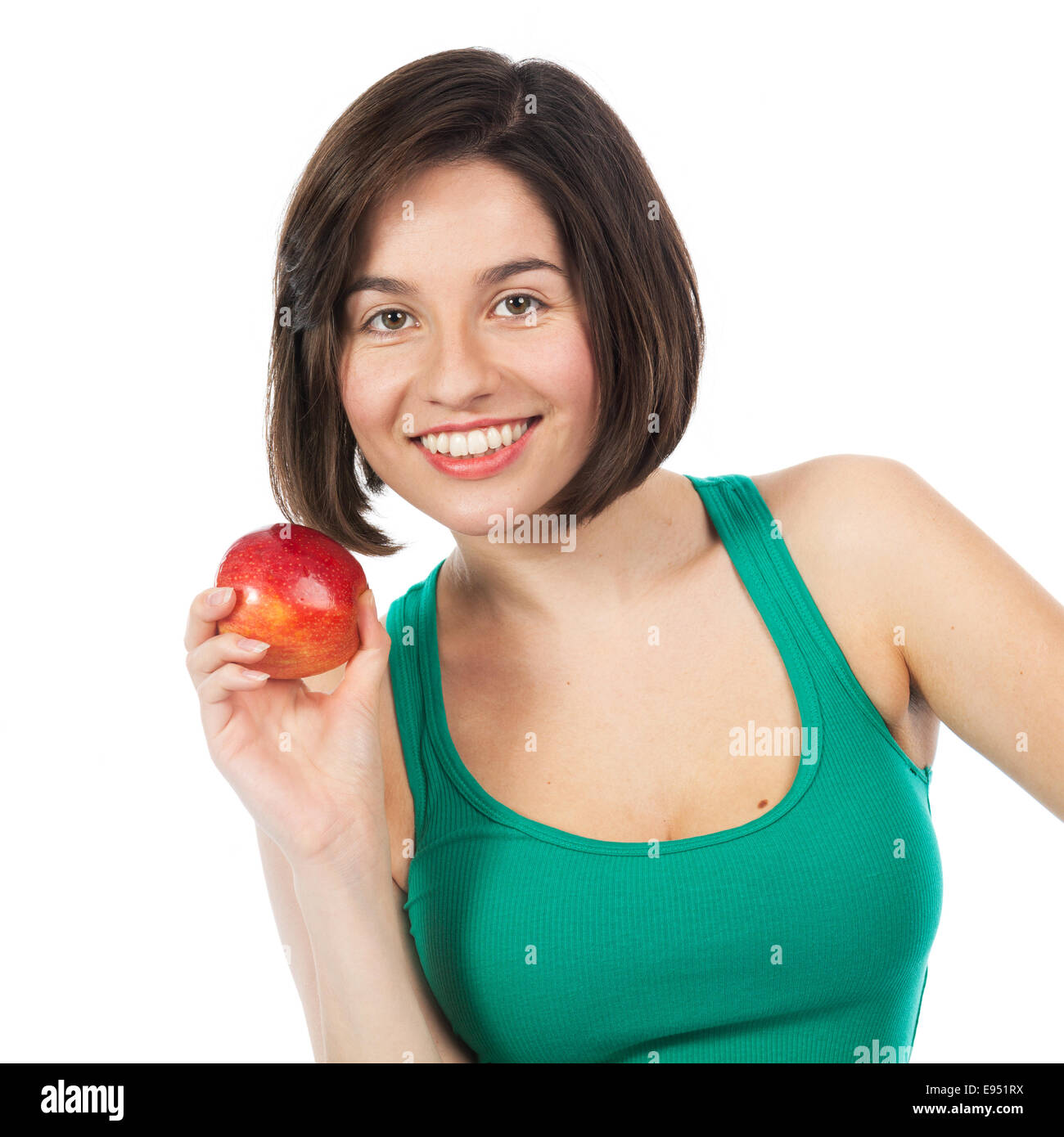 Giovane e bella bruna tenendo una mela rossa, isolato su bianco Foto Stock