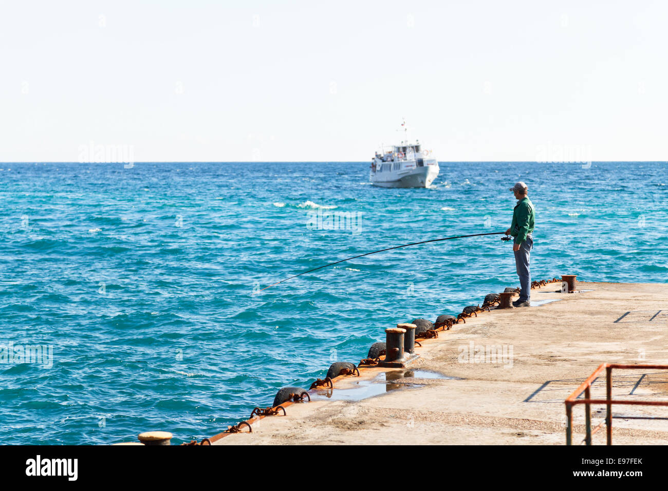 GASPRA, Russia - 29 settembre 2014: i pescatori sul molo pesce dall'asta nel Mar Nero. Circa 160-190 specie di pesci vivono in nero Foto Stock