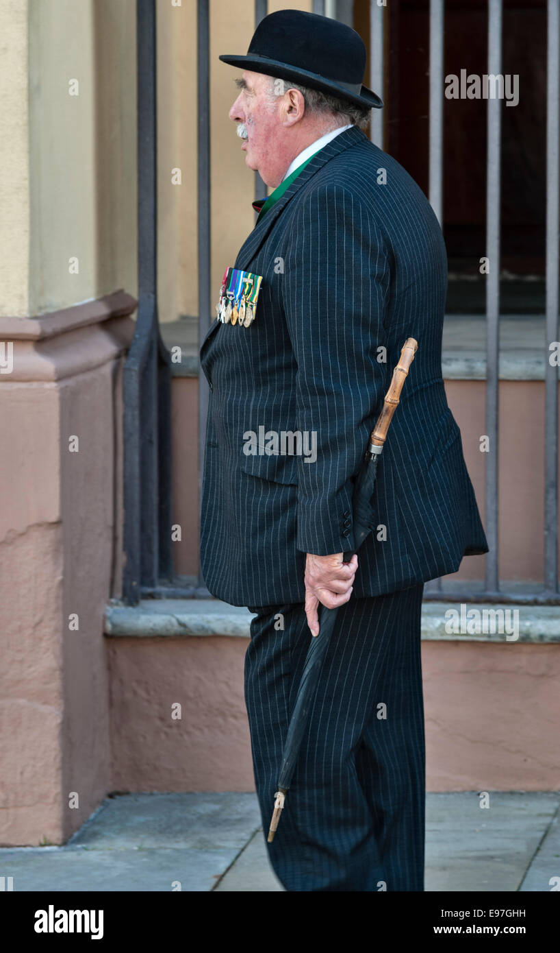 Un ex soldato anziano che assiste a una parata militare, vestito in modo intelligente e indossando le sue medaglie di servizio (Regno Unito) Foto Stock
