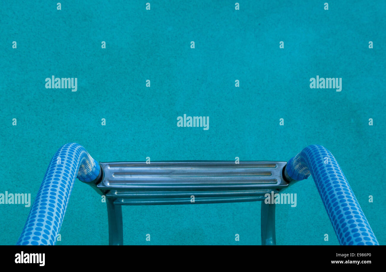 La scala di colore blu della piscina di acqua a bordo piscina corrimano Foto Stock