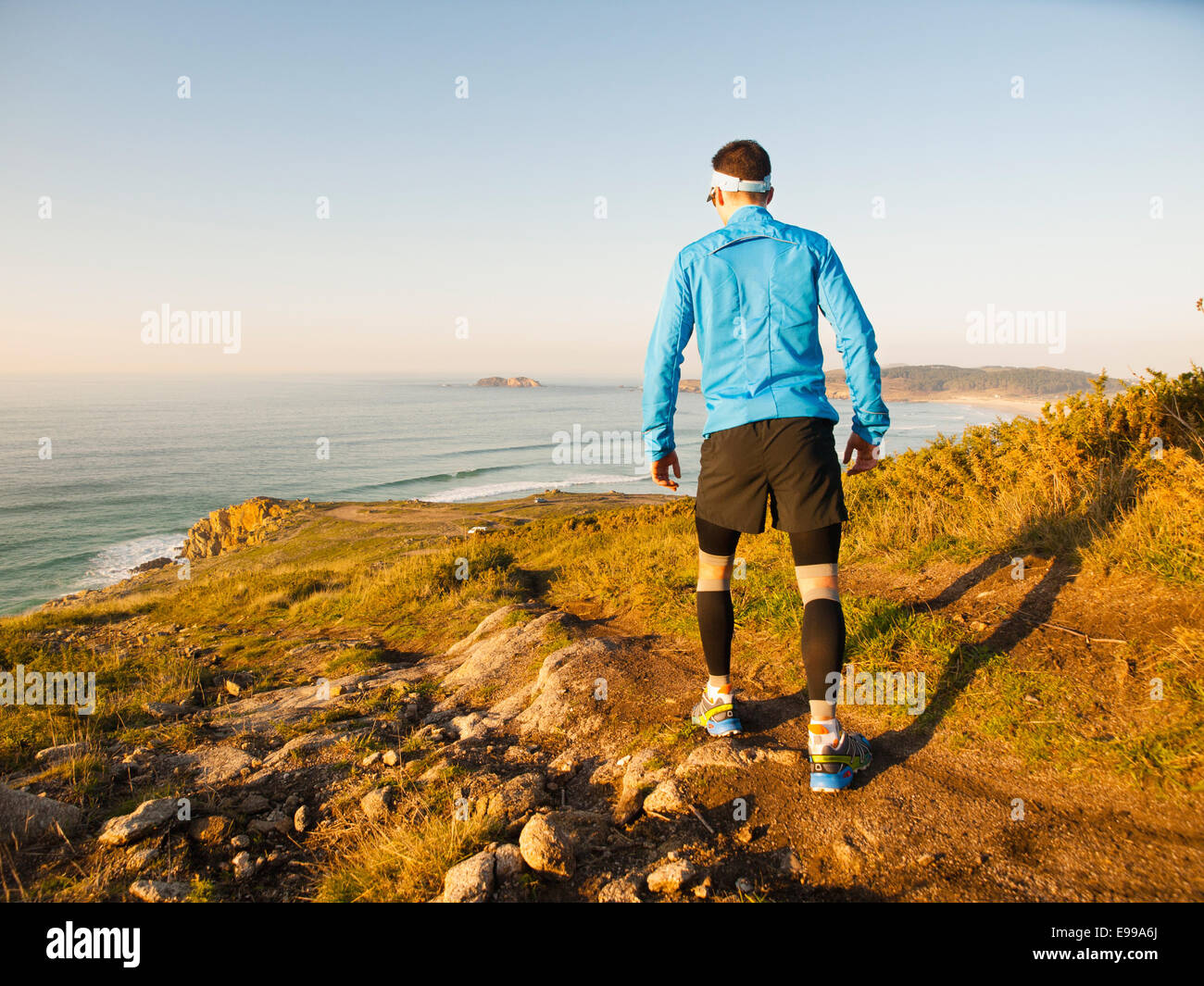 Uomo che cammina in un sentiero con un paesaggio in background Foto Stock