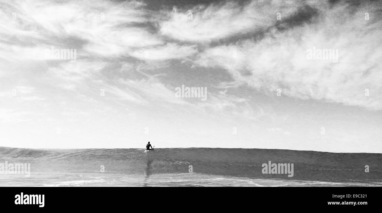 Surfer sulla cima di una grande onda in bianco e nero Foto Stock