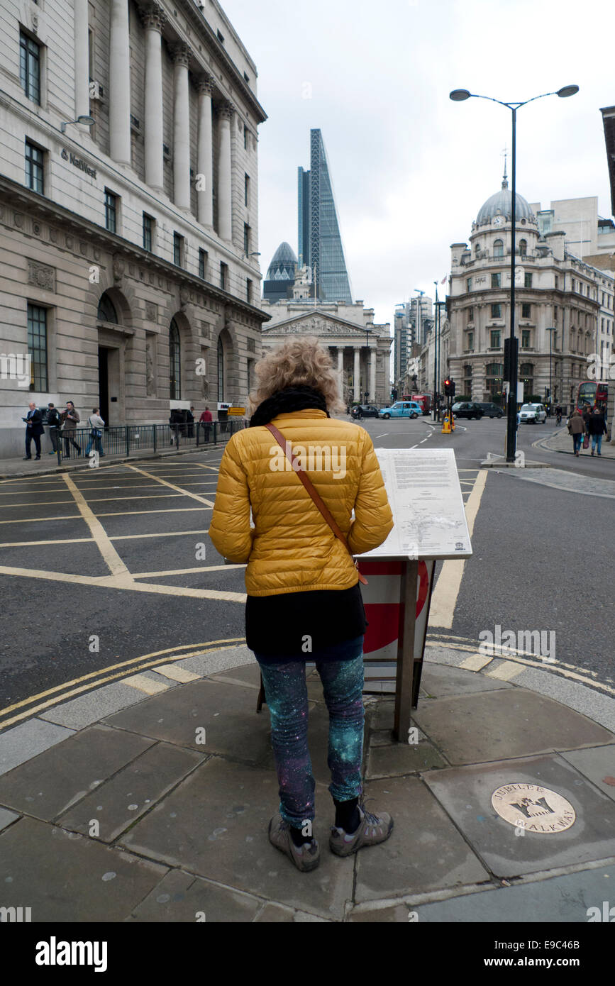 Londra, Regno Unito. 24 ottobre, 2014. Presso la Banca intersezione di 5 strade nella città di Londra un pedone assegni turistici un pannello di informazioni mappa di orientare se stessa in relazione al gherkin, Leadenhall Building e Royal Exchange. Credito: Kathy deWitt/Alamy Live News Foto Stock