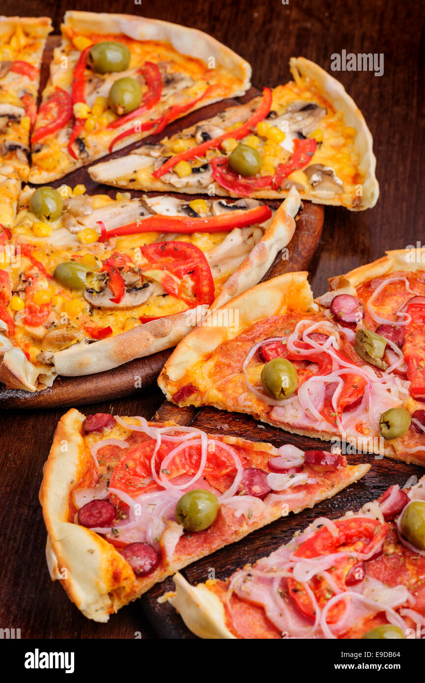 Pizza con pomodoro, salame, peppeeoni, olive e giallo pepe caldo Foto Stock