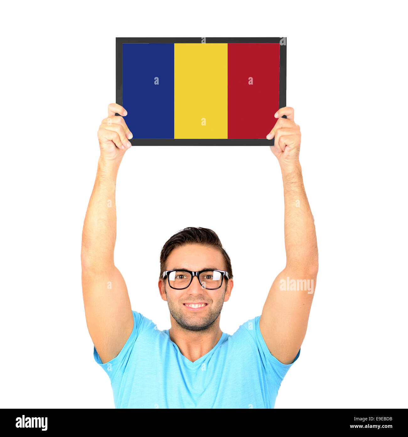 Ritratto di un giovane uomo informale tenendo su scheda con bandiera nazionale della Repubblica di Romania Foto Stock