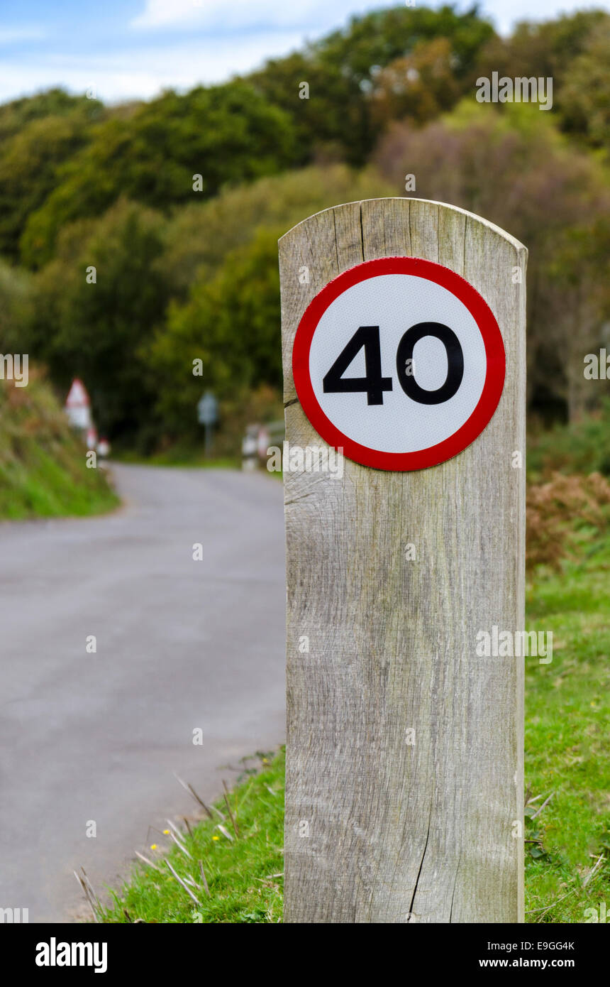 40 mph circolare su strada britannica segno su un montante in legno post Foto Stock