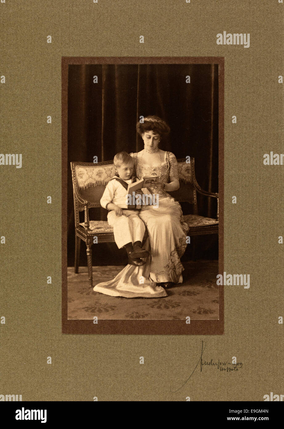 Dronning Maud leser per Kronprins Olav, 1909 Foto Stock