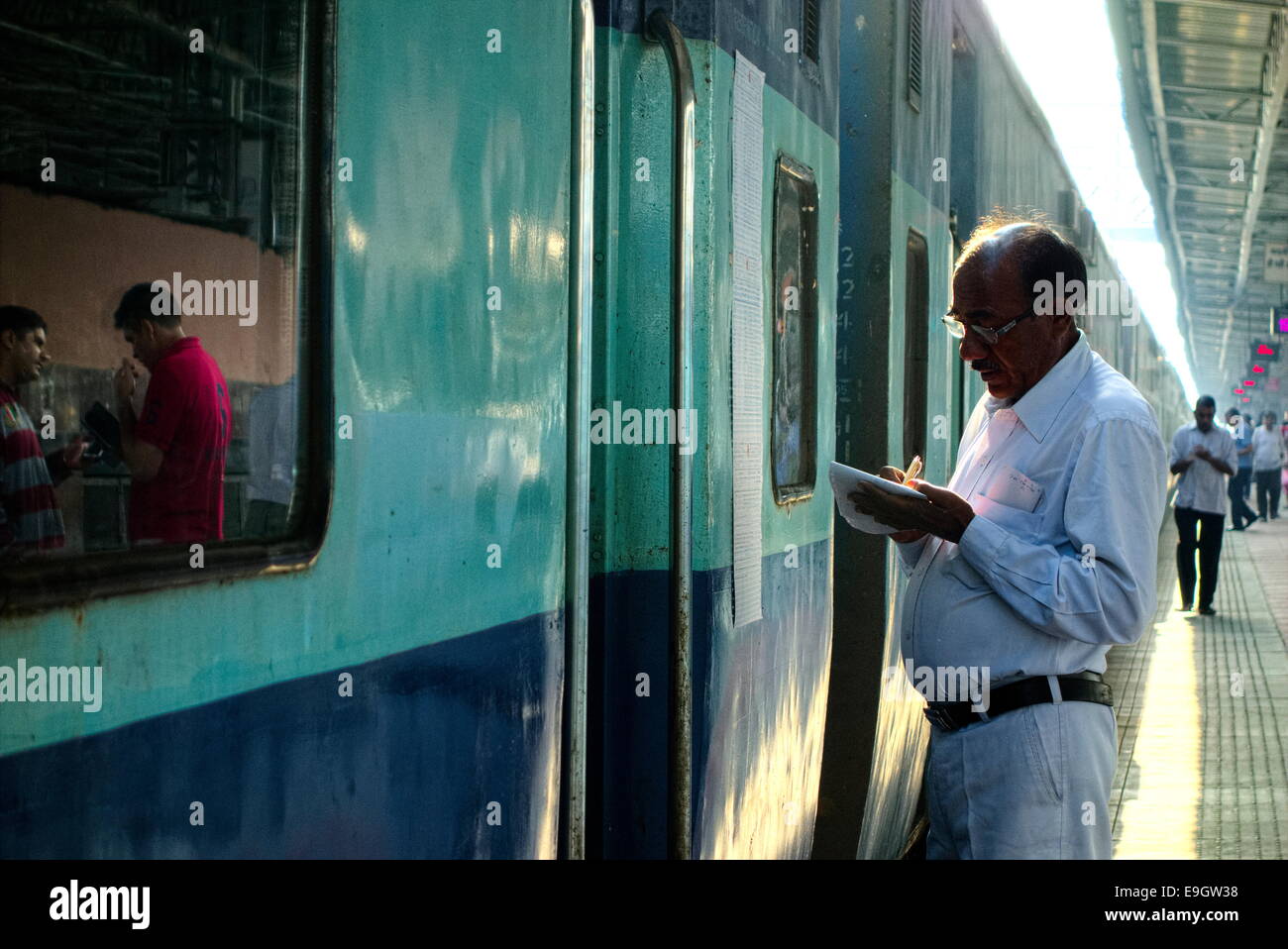 Lavoratore preparare l'elenco dei passeggeri per il prossimo treno Foto Stock