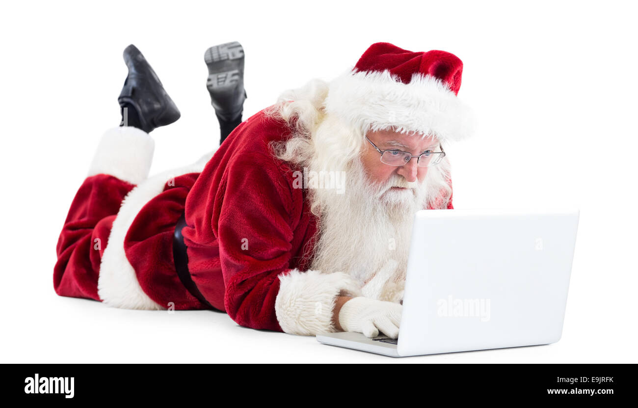 Santa si trova nella parte anteriore del suo computer portatile Foto Stock Santa si trova nella parte anteriore del suo computer portatile Foto Stock