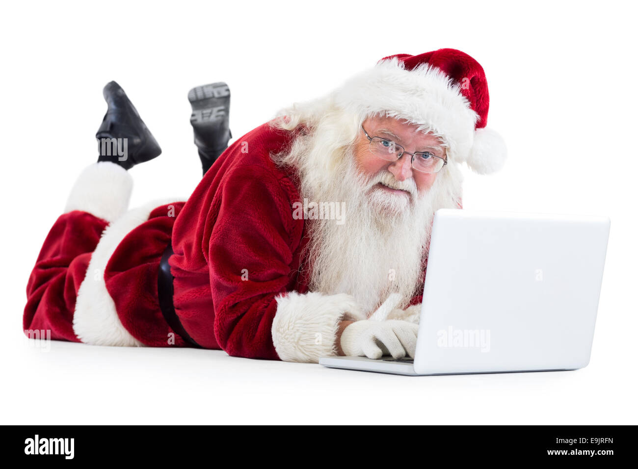 Santa si trova nella parte anteriore del suo computer portatile Foto Stock Santa si trova nella parte anteriore del suo computer portatile Foto Stock