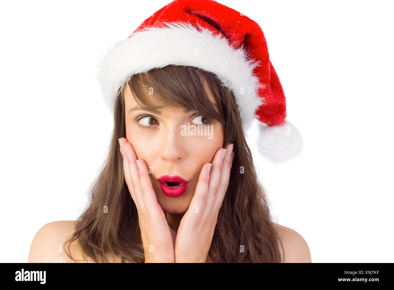 Festive brunette guardando sorpresi con le mani sul viso Foto Stock