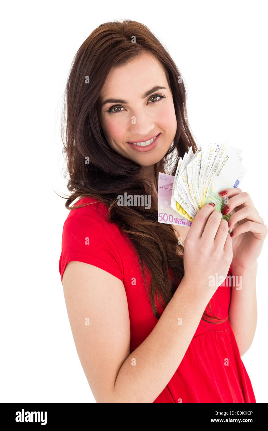 Allegro brunette tenendo il suo cash Foto Stock