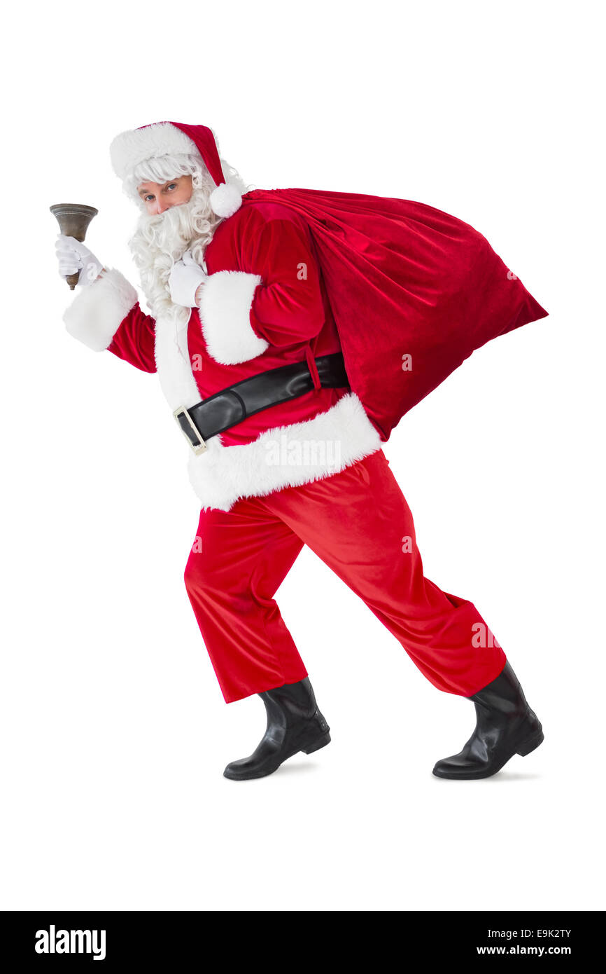 Santa camminando con il suo sacco e bell Foto Stock