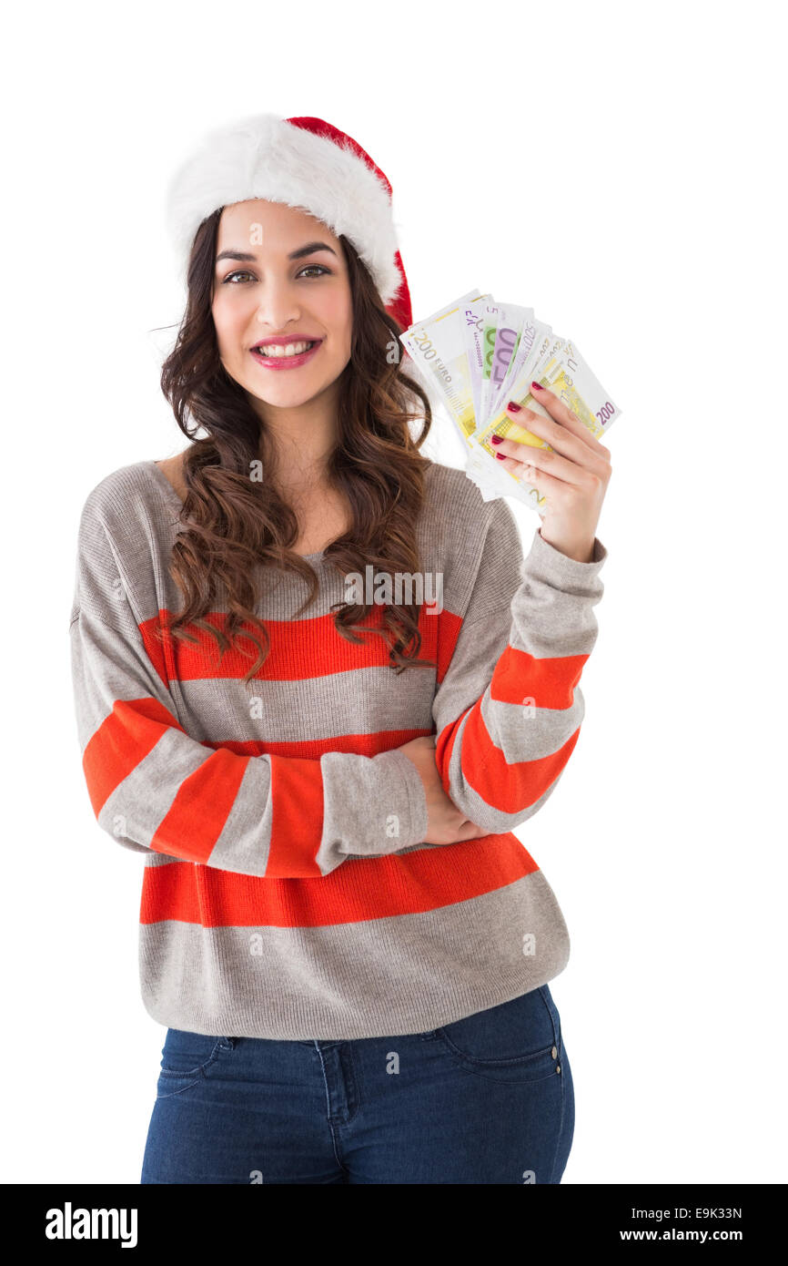 Festive brunette tenendo il suo cash Foto Stock