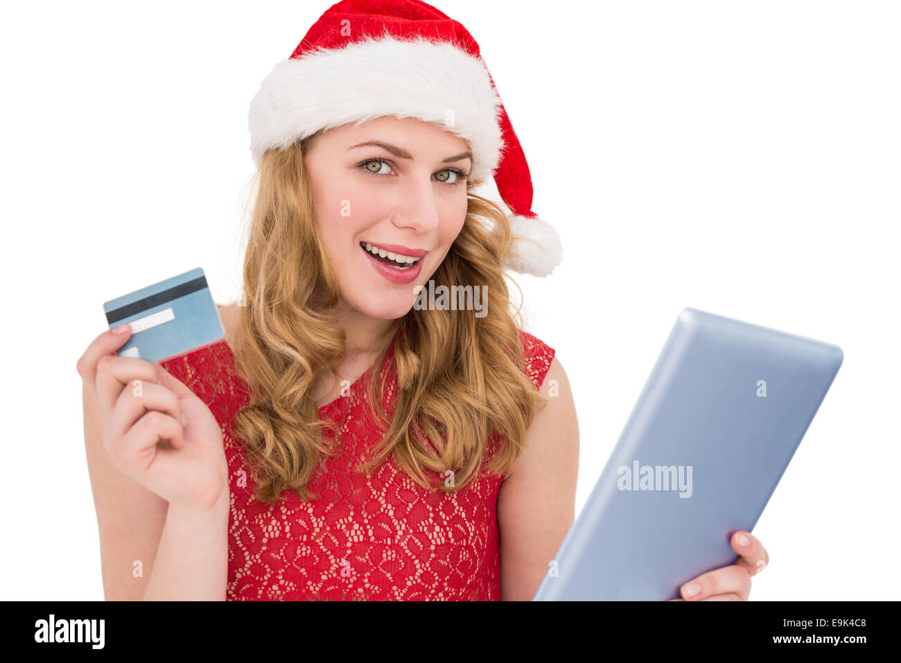 Festive donna bionda utilizzando la sua carta di credito e tablet pc Foto Stock
